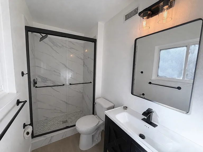 Remodeled primary bathroom with contemporary finishes